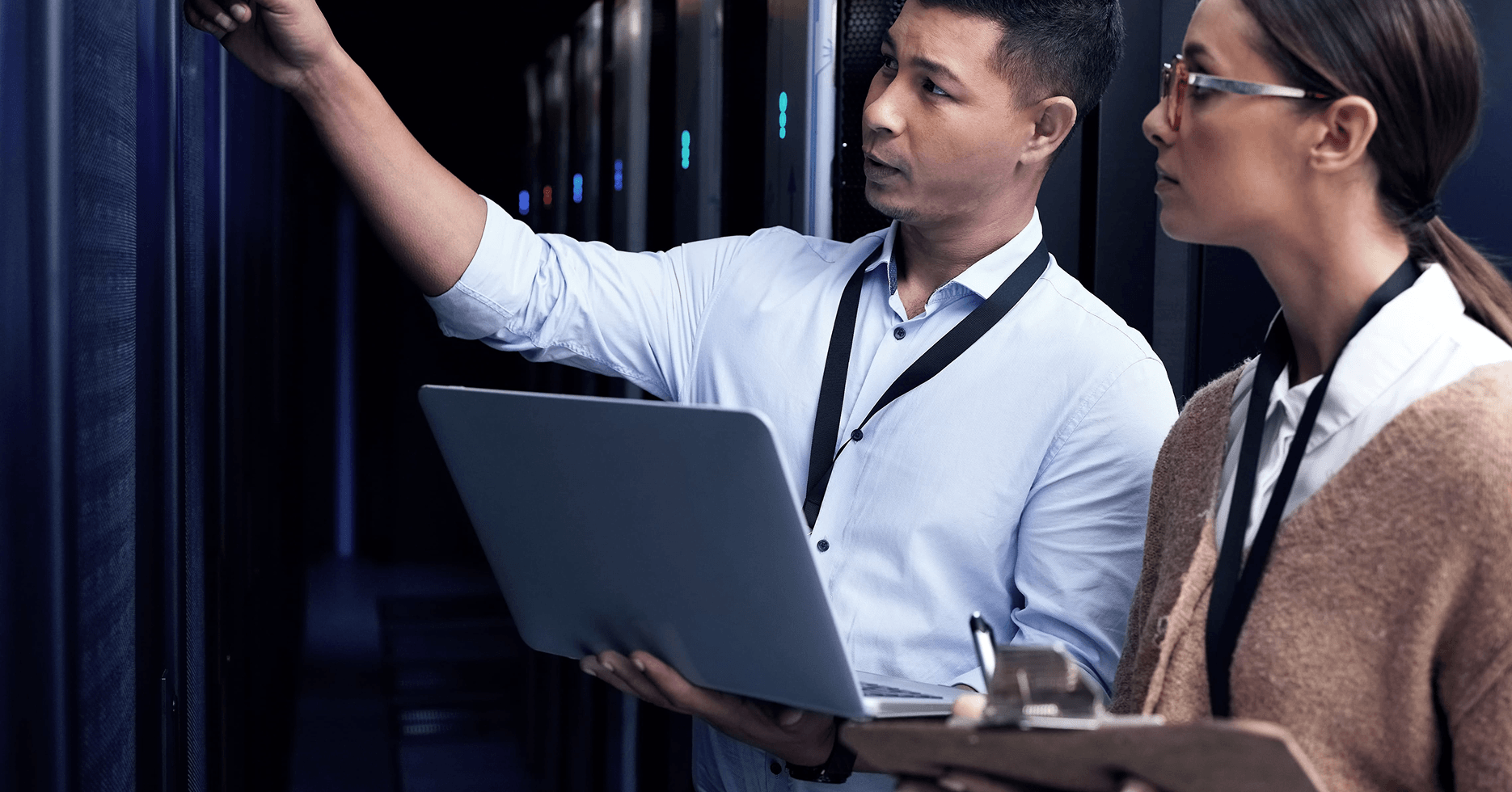 two colleagues checking backup services in server room