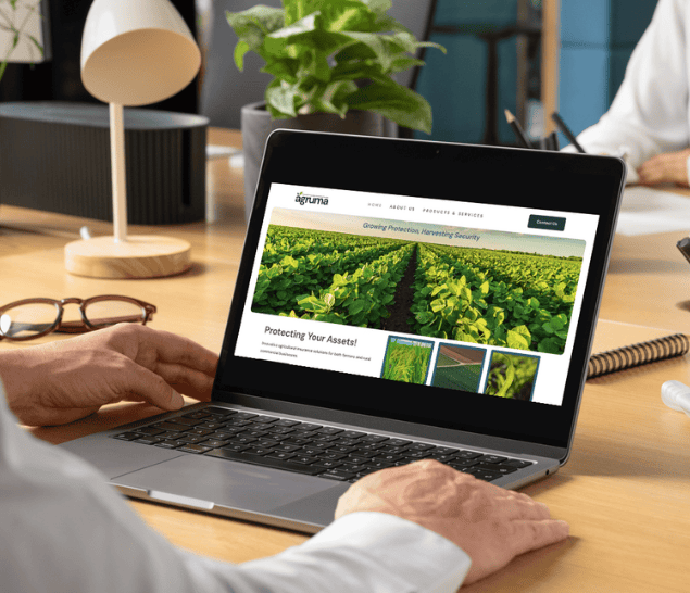 Agruma website shown on laptop device in office setting